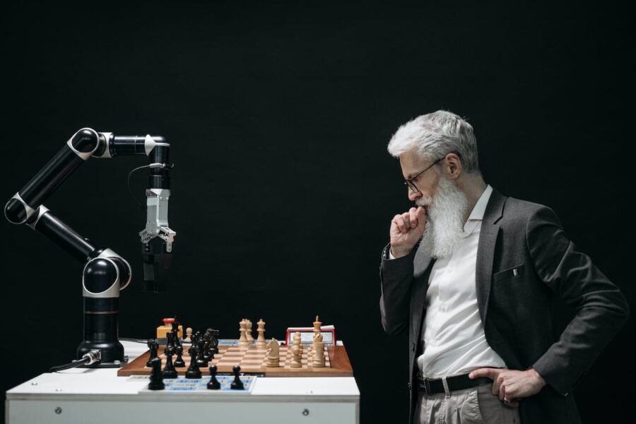 Image of man playing chess against a robot AI