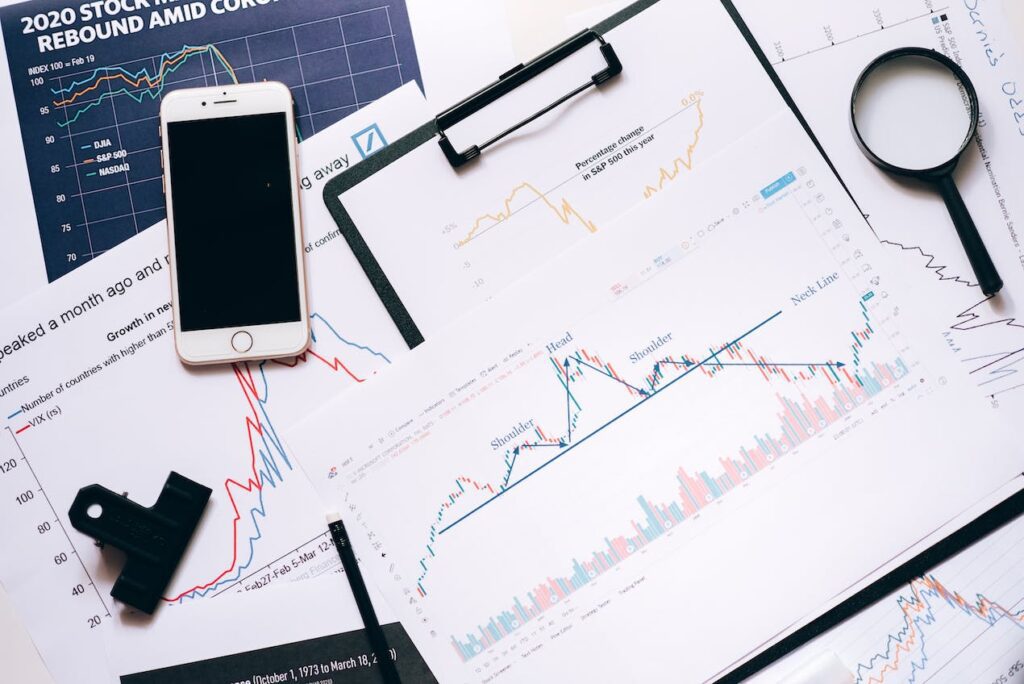 paper showing user research data with phone and magnifier beside the paper