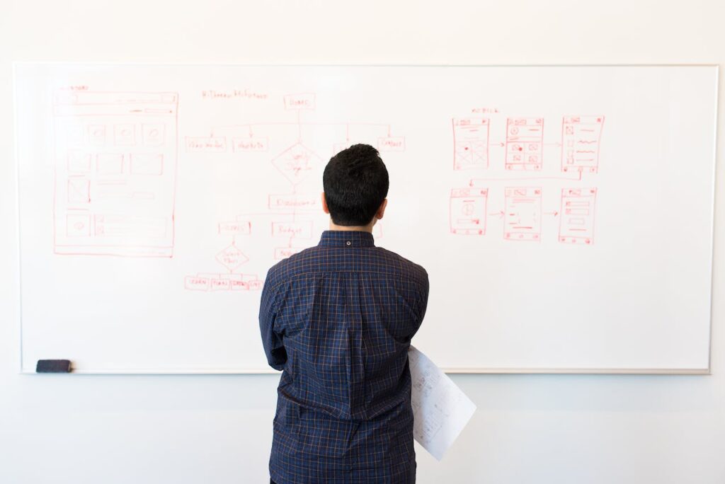 man looing at data on the board