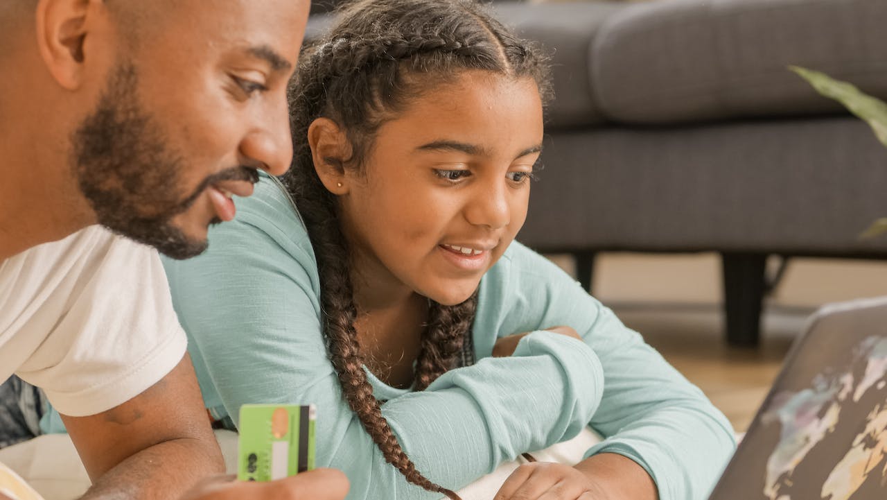 customer: man and child smiling about to make a purchase 