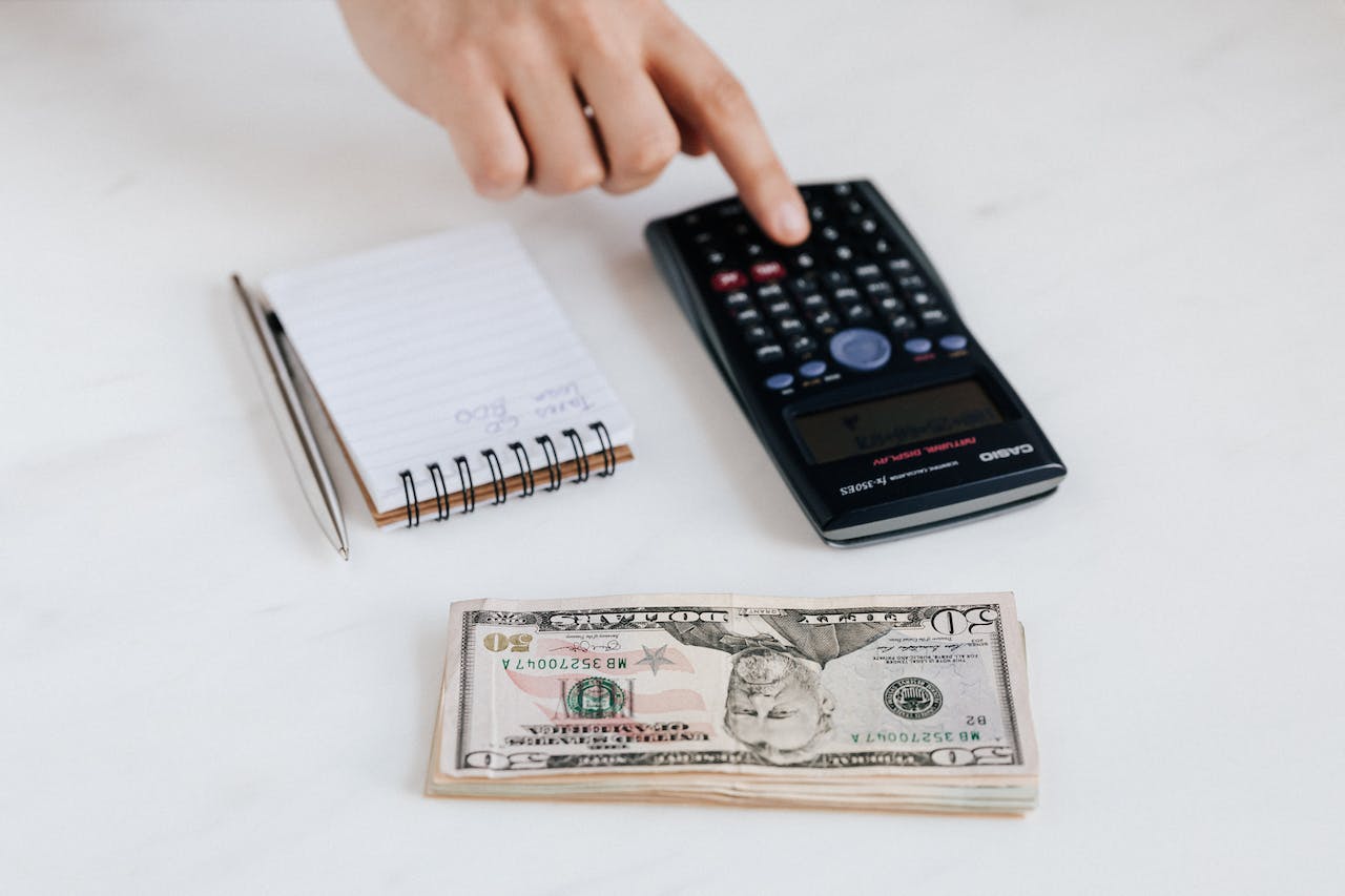 image of money calculator and jotter on a tabble