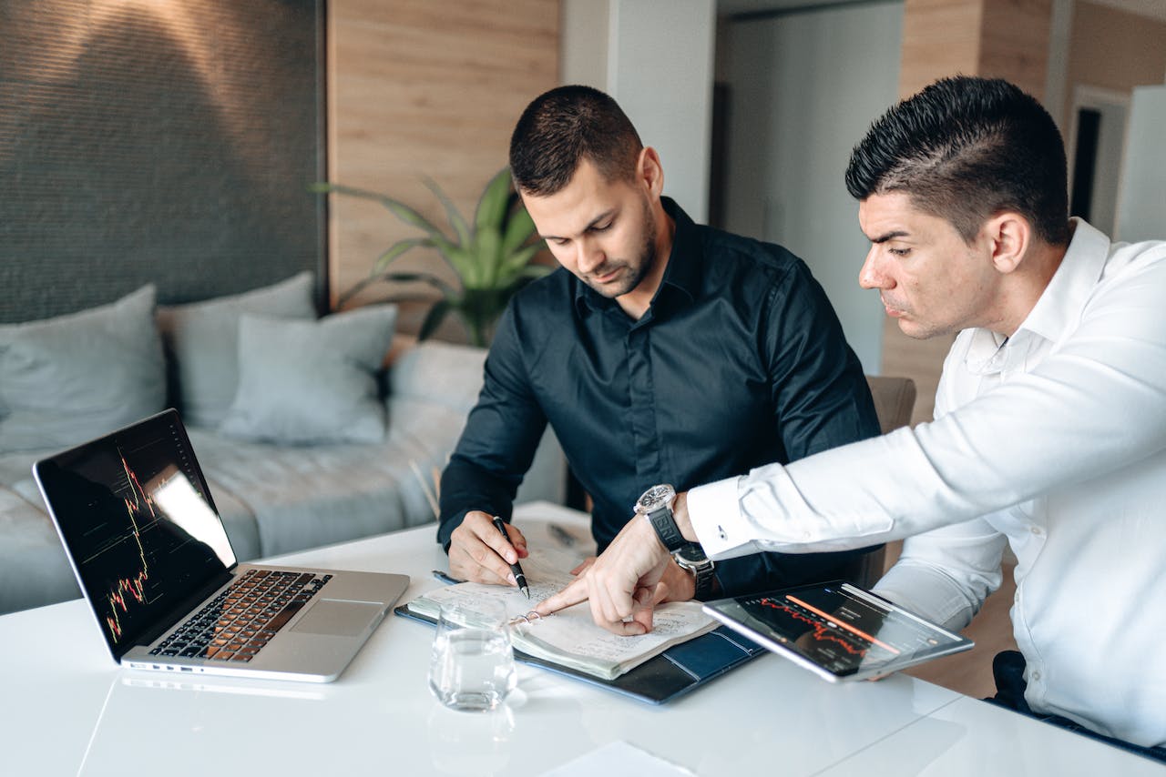 image of man 2 men in black discussing strategy