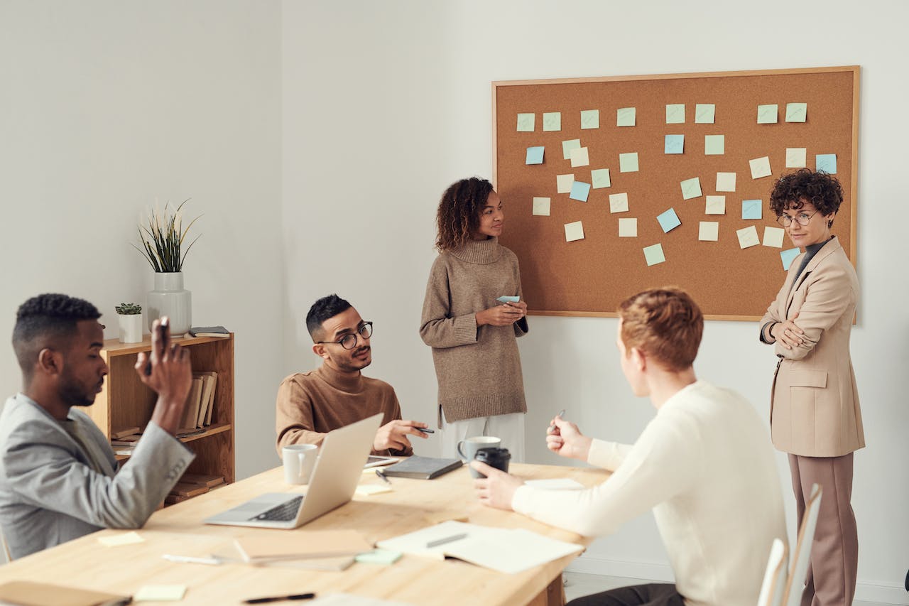 team member brainstorming segmenting ideas on a board