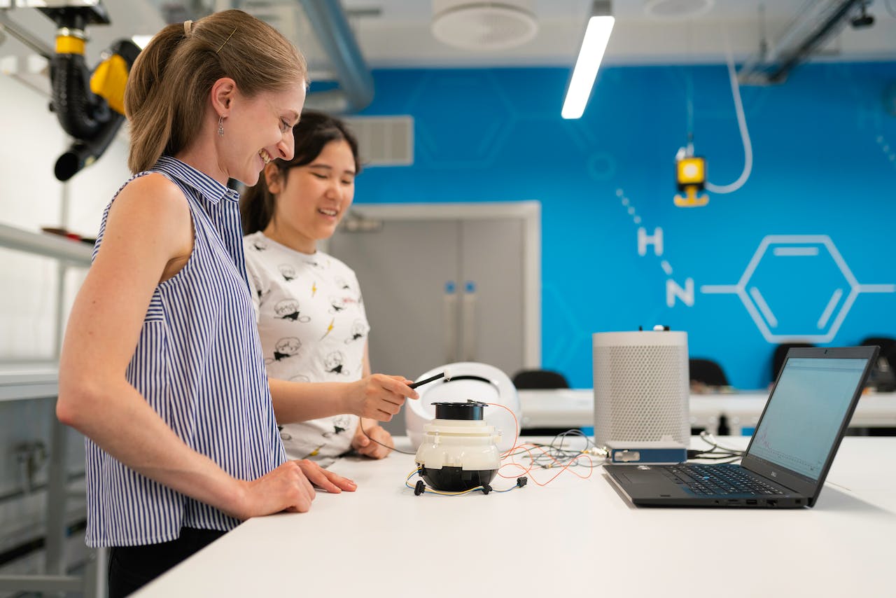 two ladies smiling as the user test a product